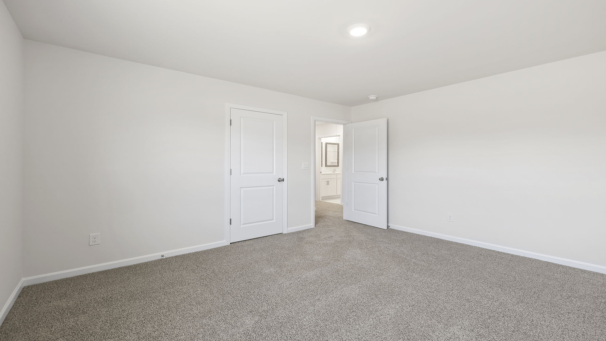 Bedroom with window and carpet.