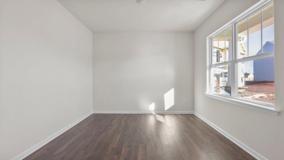 Dining room at the front of the home with large windows.