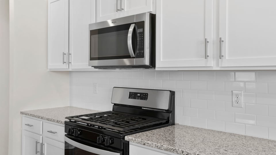 Stainless gas range and built in microwave.