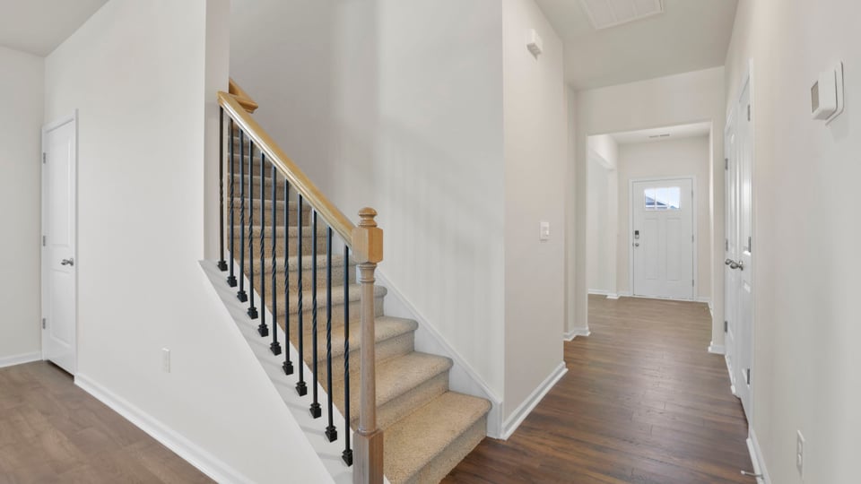 View of the stairwell and hallway to the entrancee.