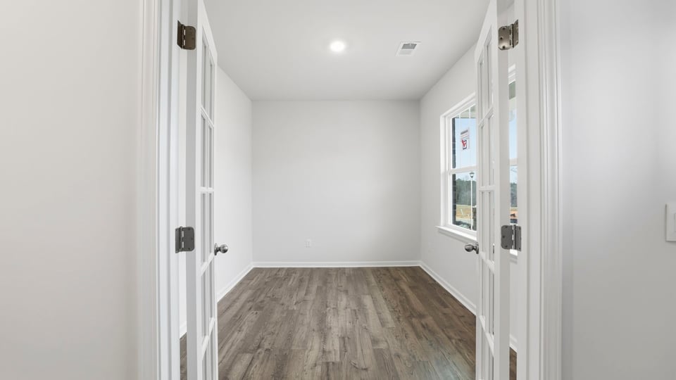 Study accented by large windows and French doors.