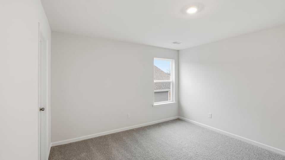 Bedroom with window and carpet.