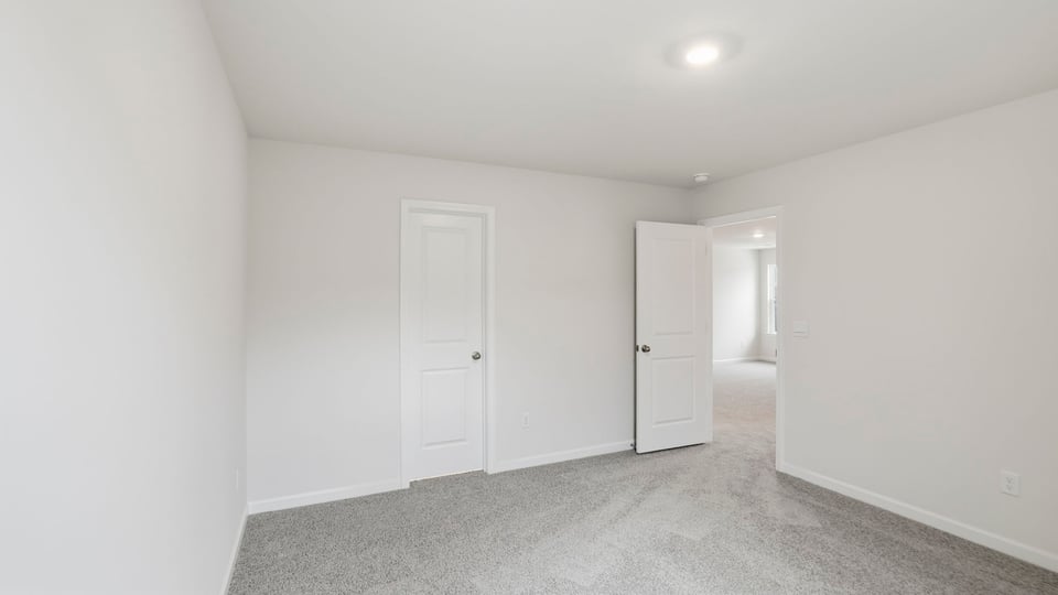 Bedroom with window and carpet.