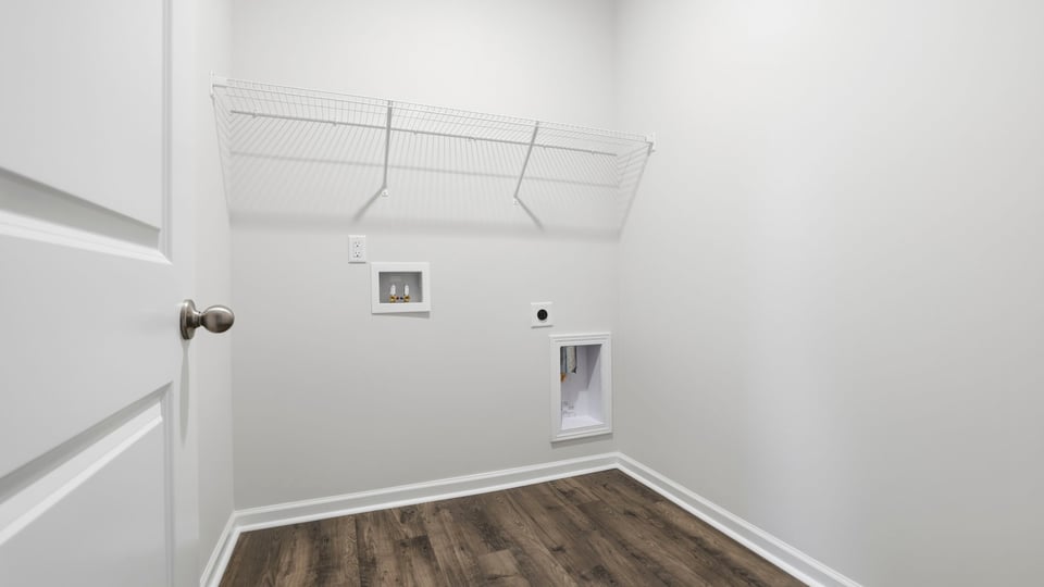 Walk-in laundry room with shelving.