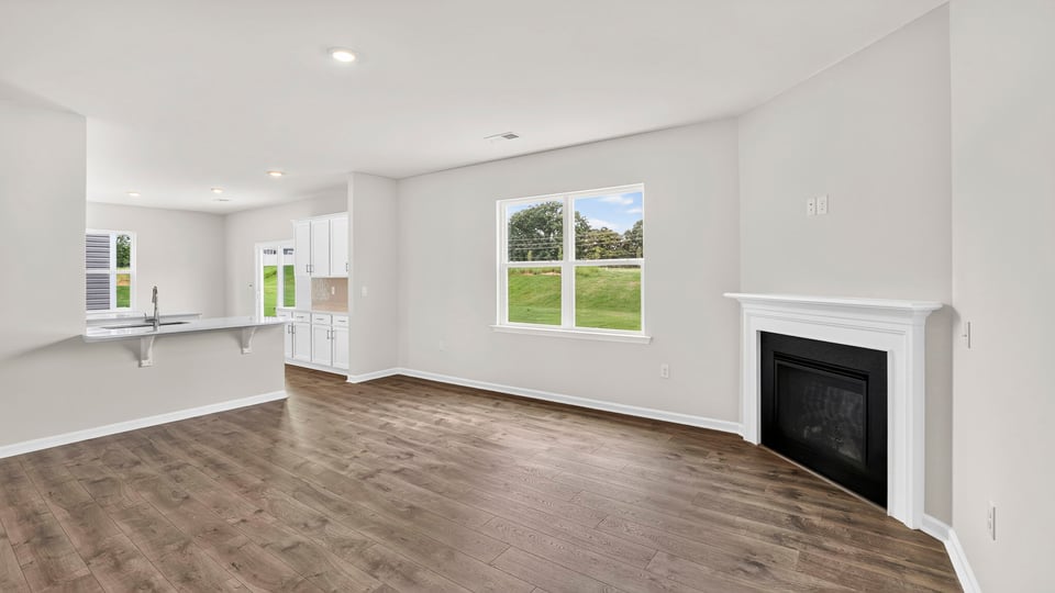 Living room with windows and fireplace.