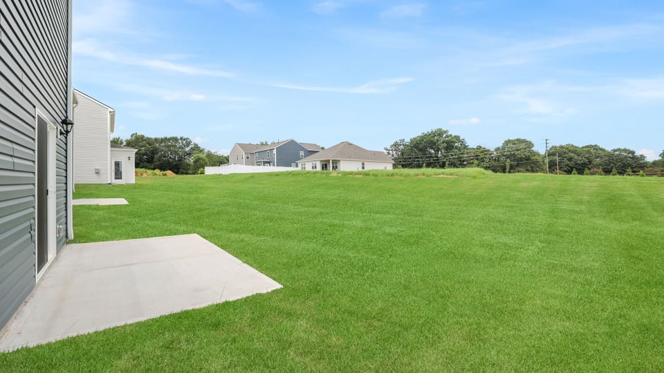 Back exterior with large backyard.