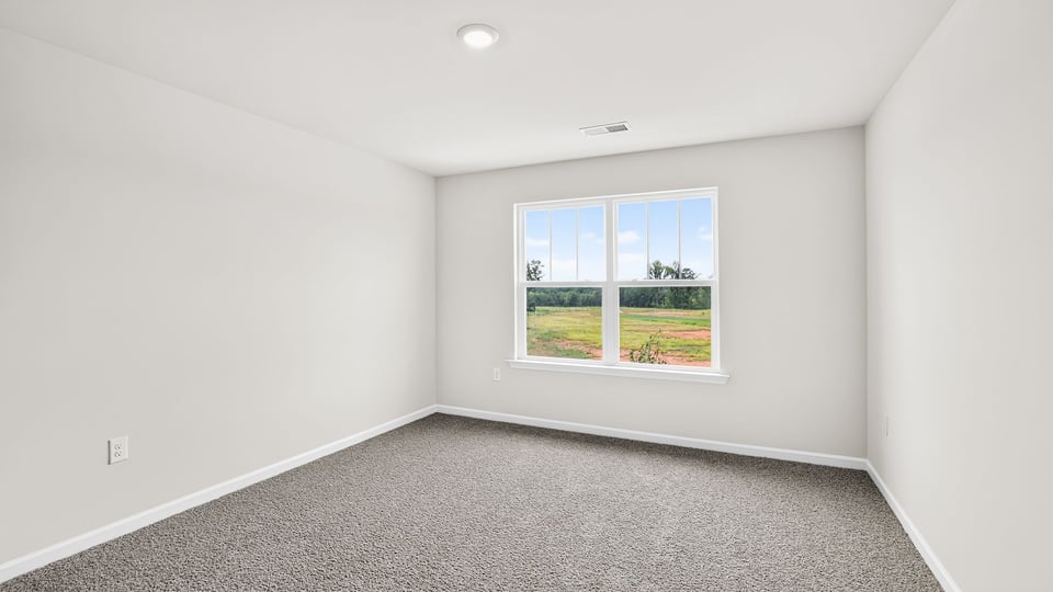 Bedroom with window and carpet.