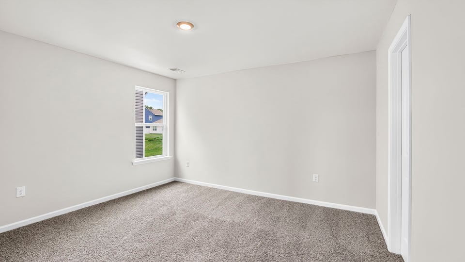 Bedroom with window and carpet.