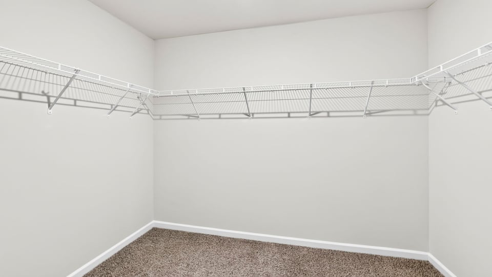 Primary bedroom walk-in closet.