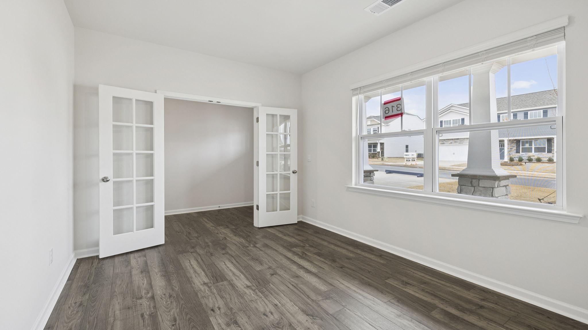 Study accented by large windows and French doors.