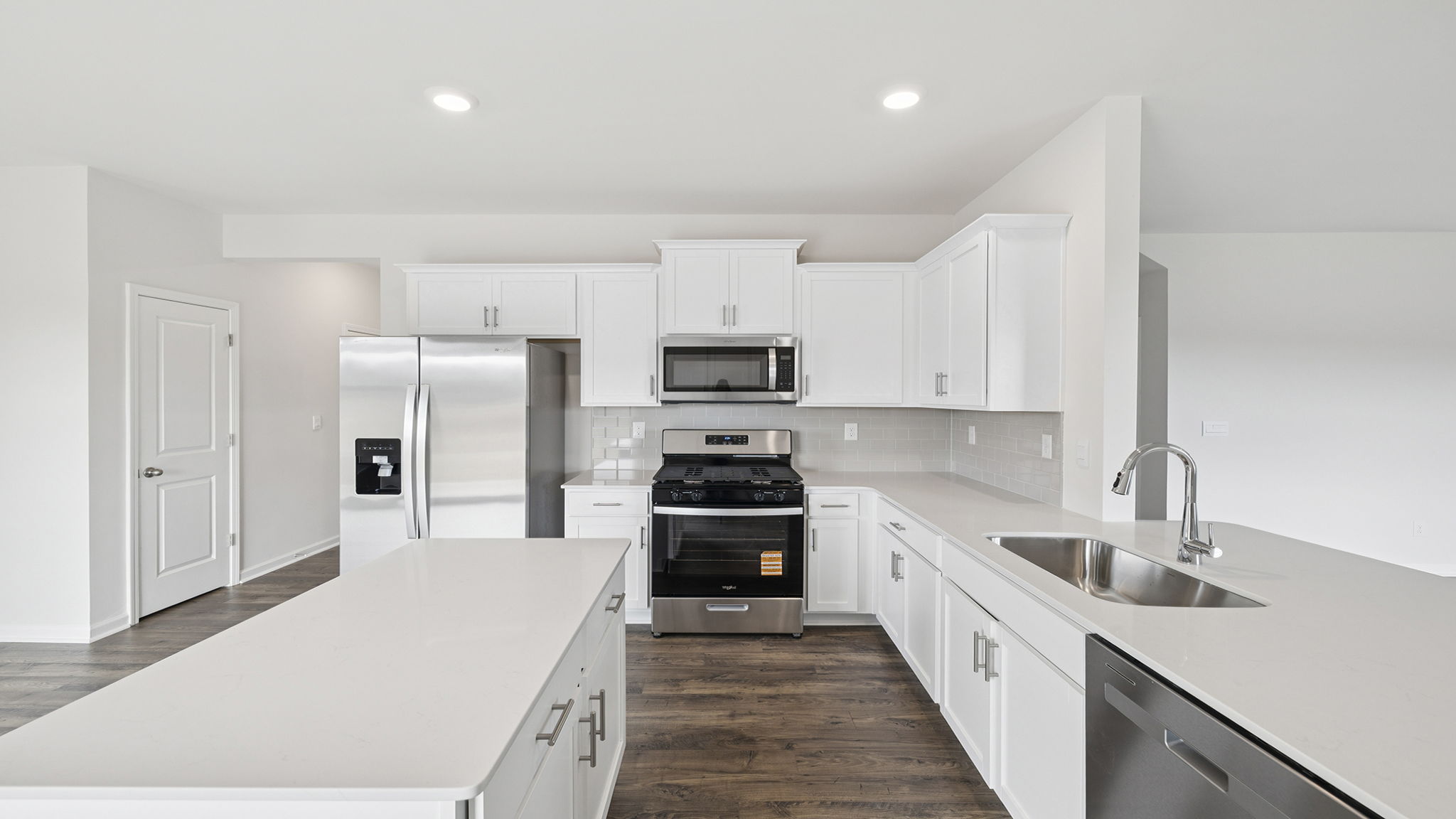 Open kitchen with island and recessed lighting.