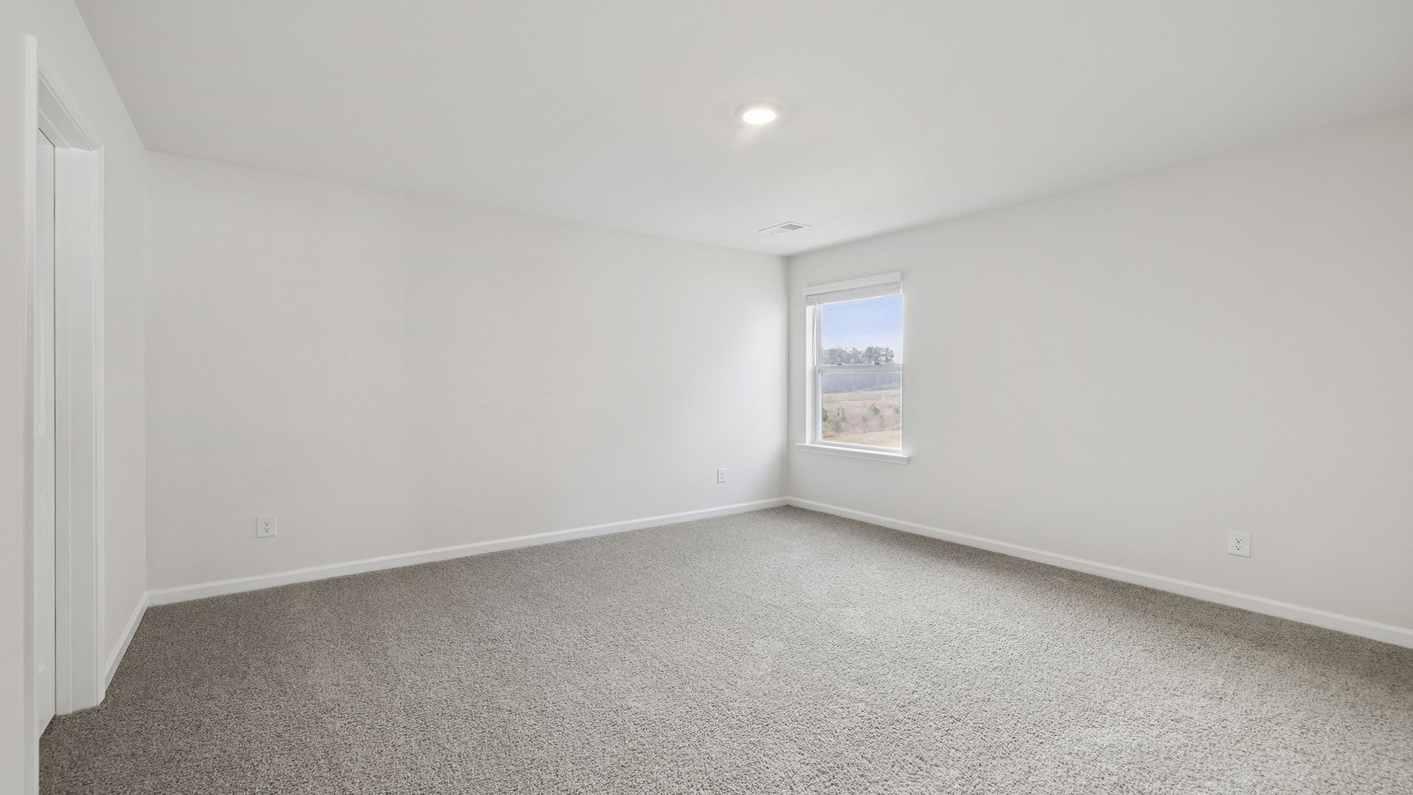 Bedroom with window and carpet.