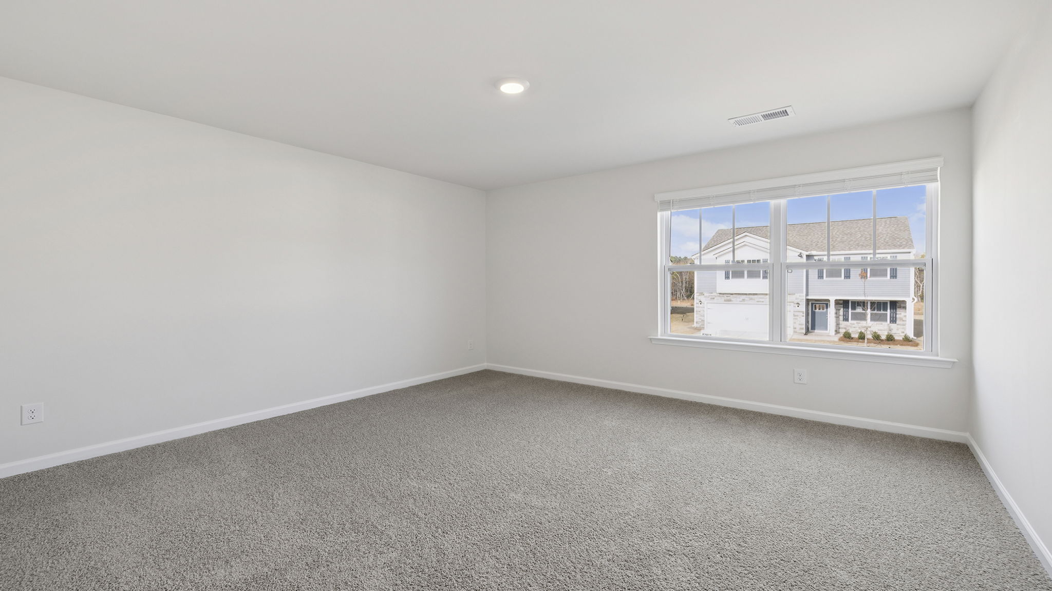 Bedroom with window and carpet.