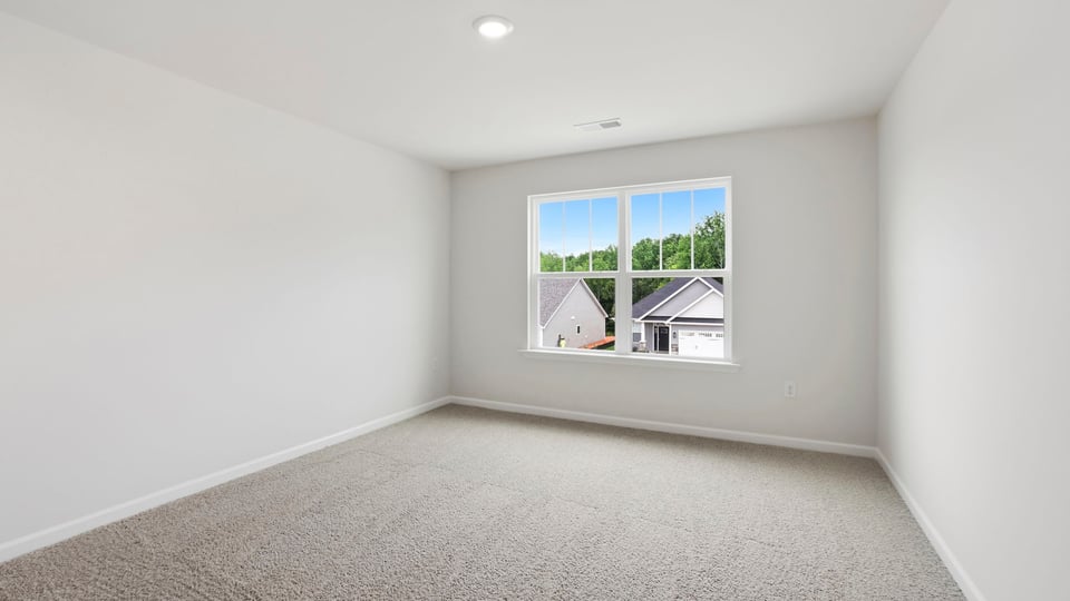 Bedroom with carpet and window.