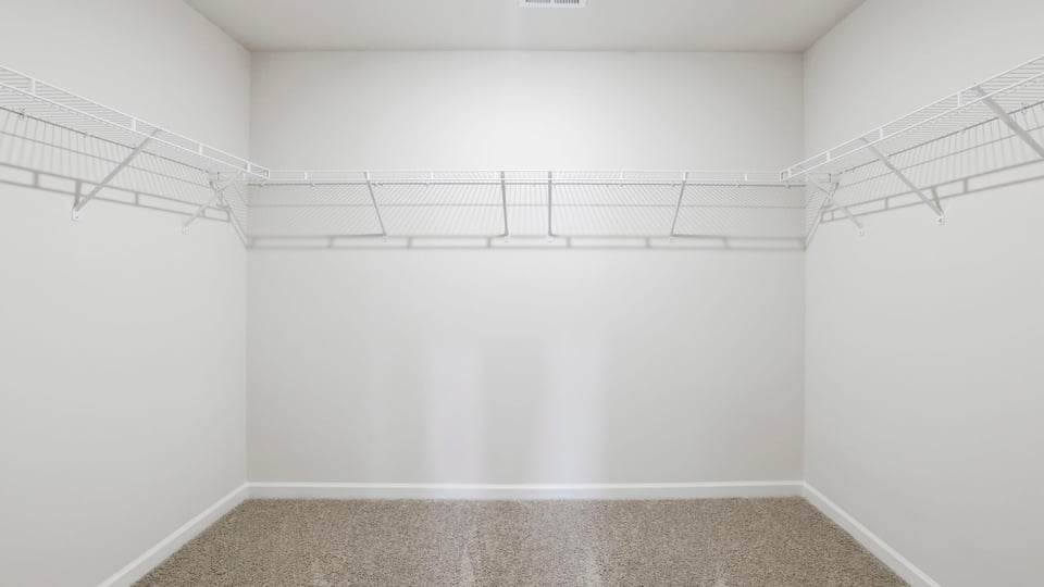 Primary closet with shelf.