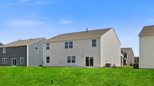Back exterior with large backyard.