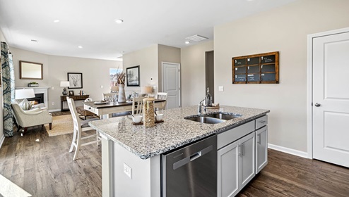 Kitchen and island with granite counter tops.