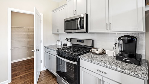Kitchen and island with granite counter tops.