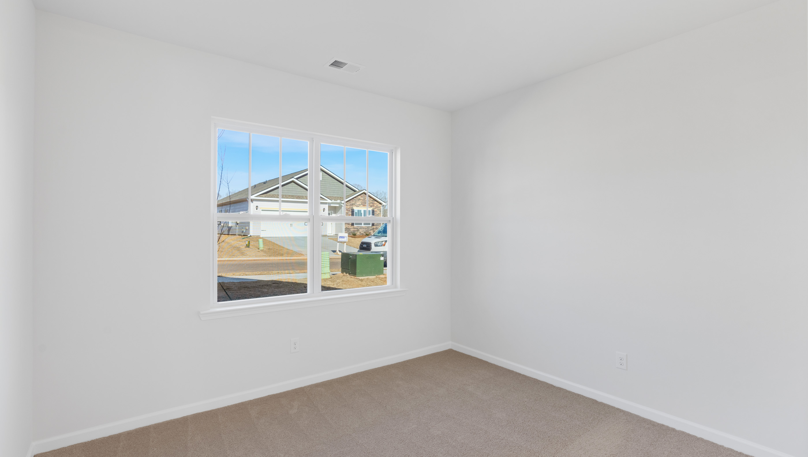 Bedroom with carpet and window.