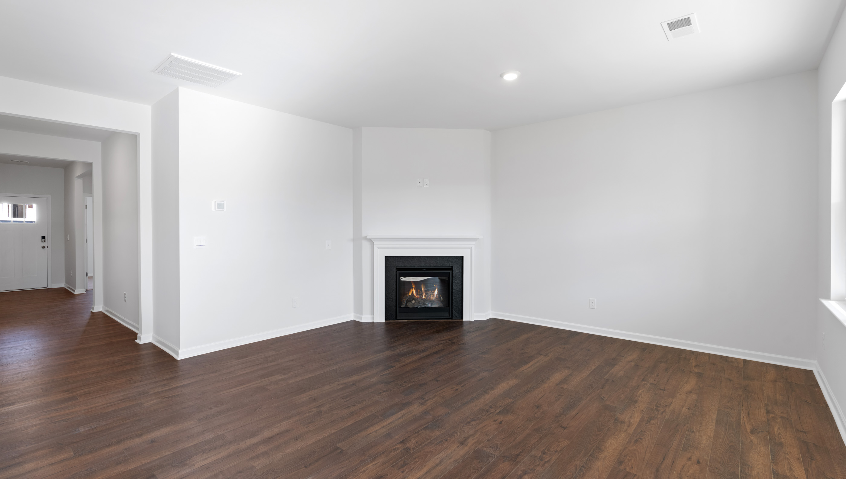 Family room with windows and fireplace.