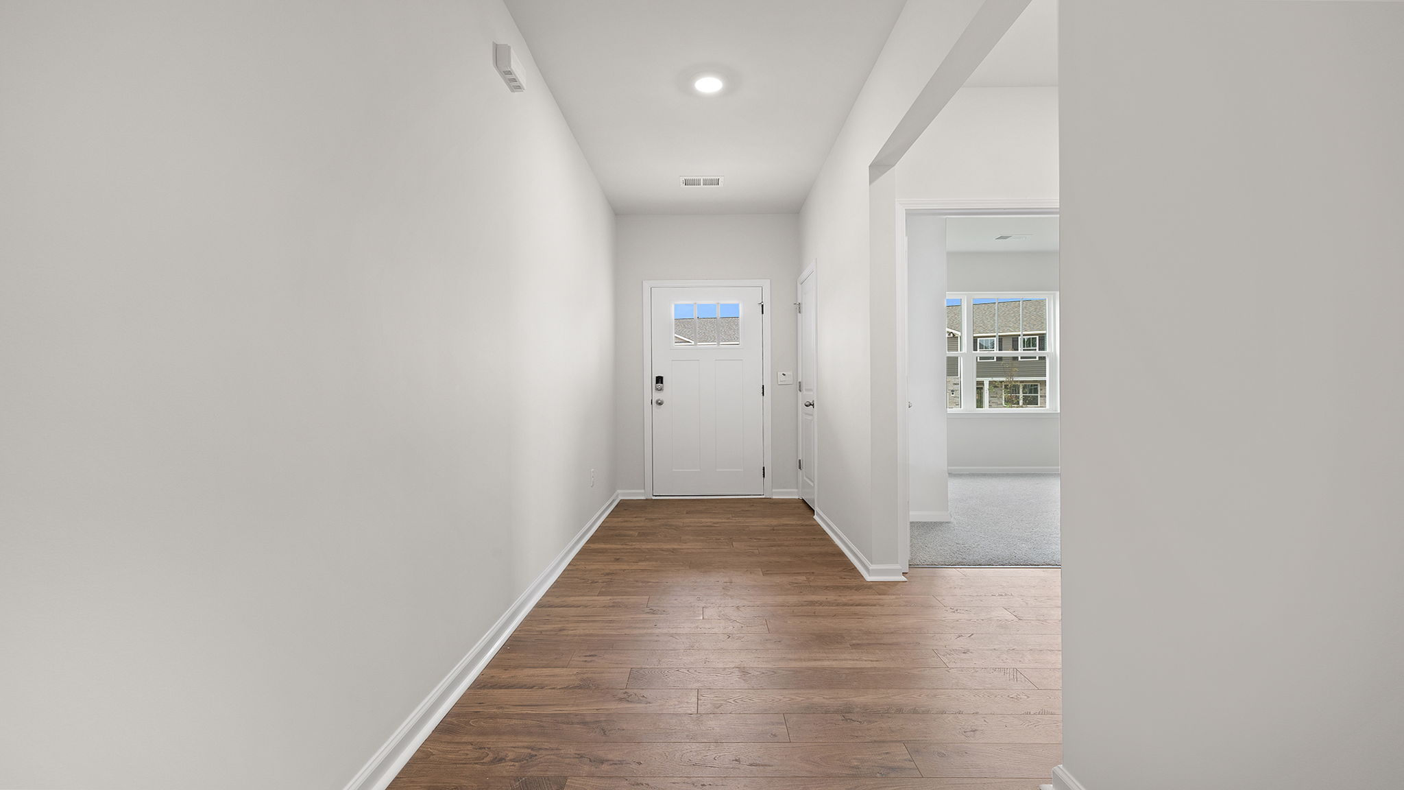 View of hallway toward the entrance and front bedroom.
