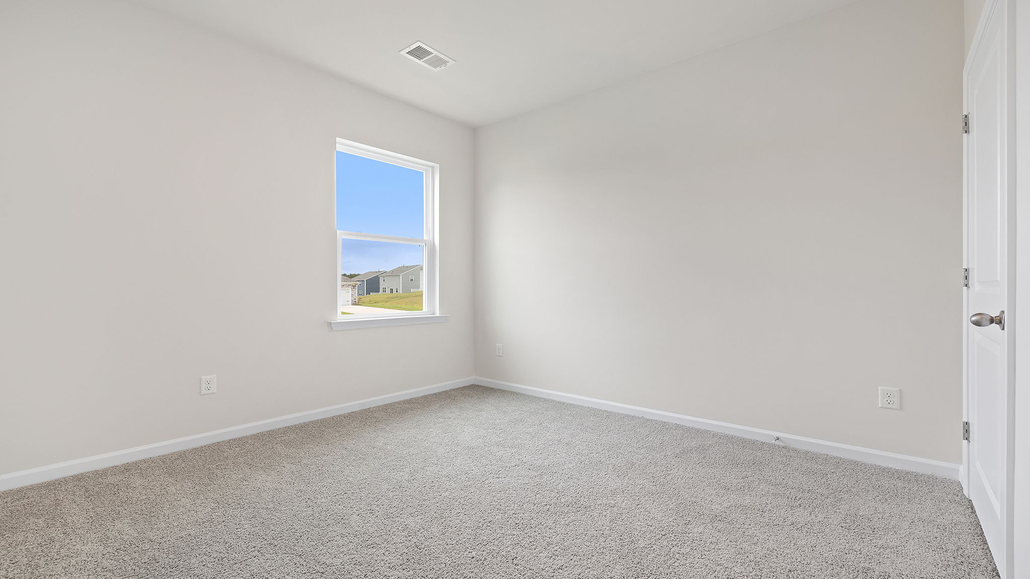 Bedroom with window and carpet.