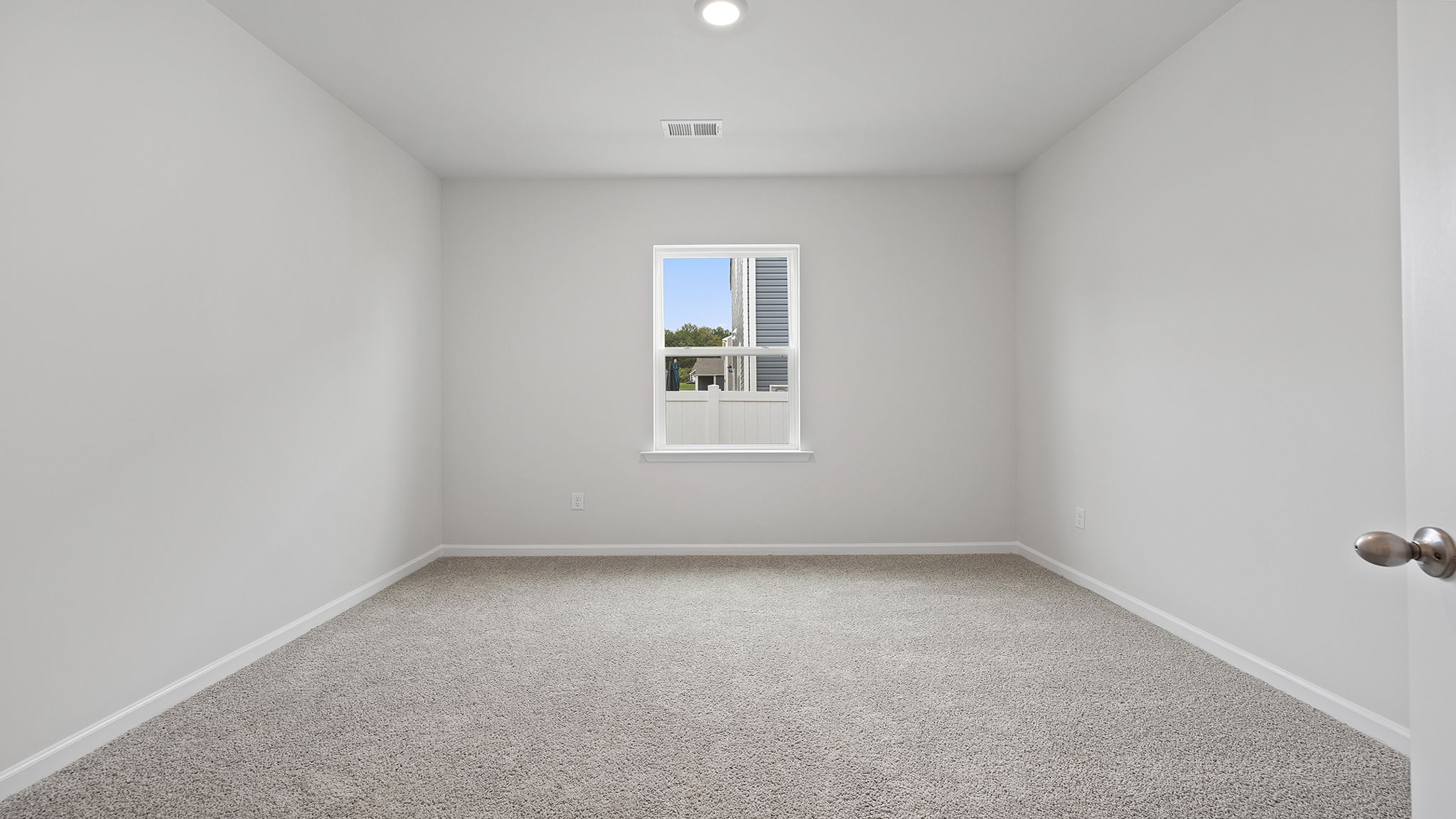 Bedroom with window and carpet.