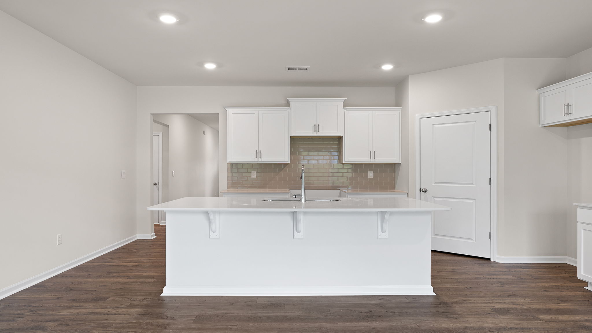 Kitchen with island and recessed lighting.