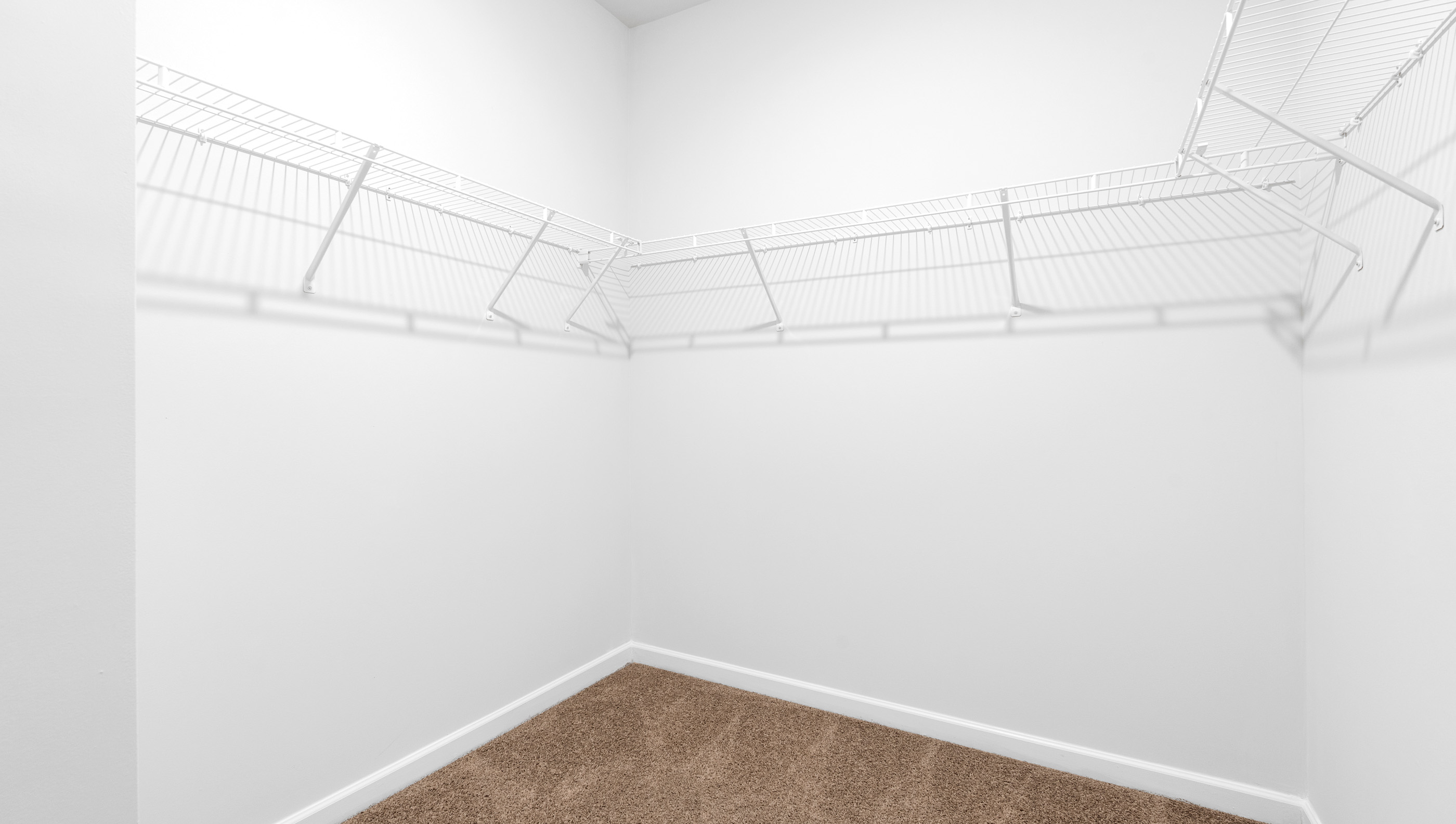 Primary closet with shelf.