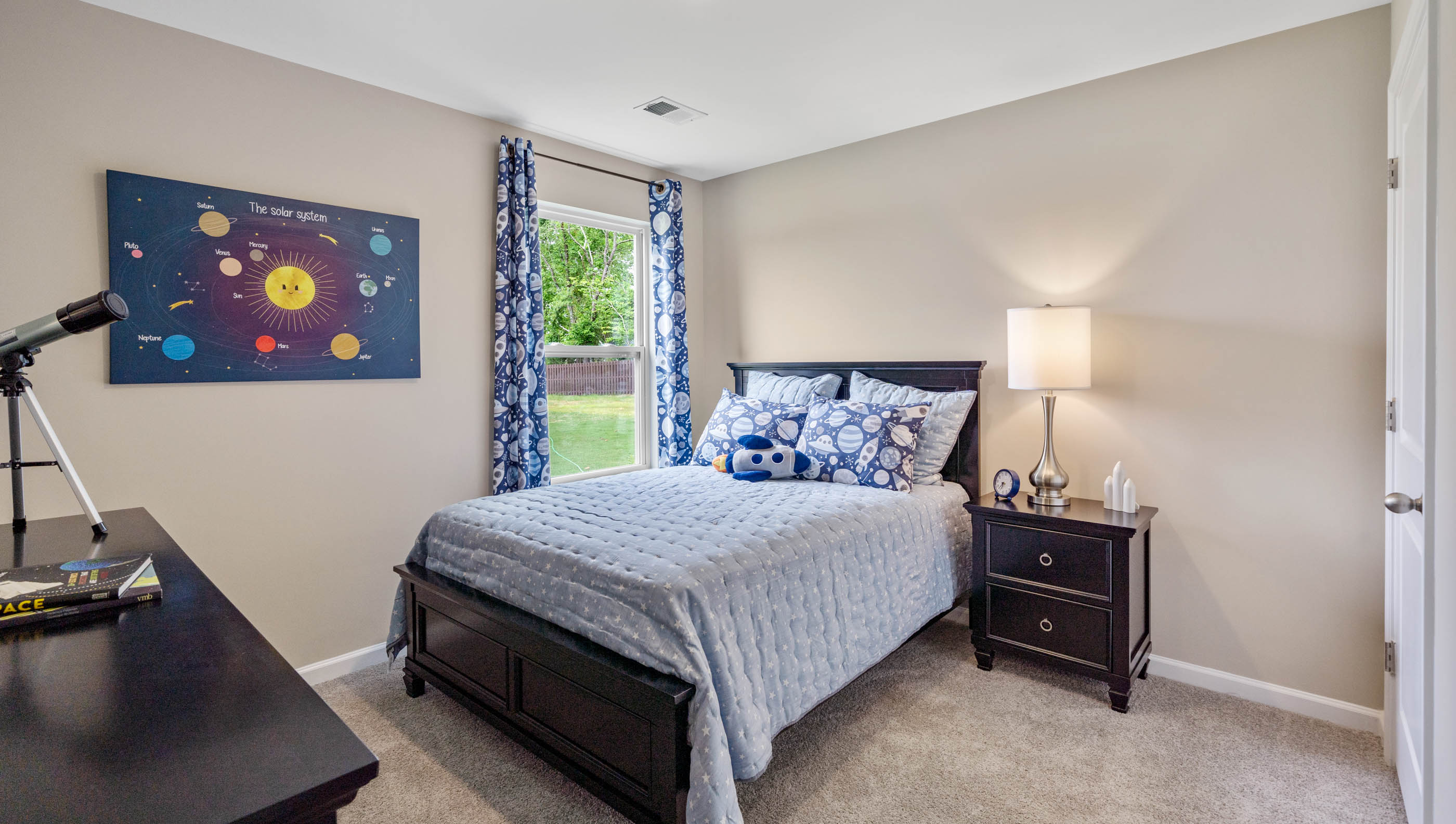 Bedroom with carpet and window.