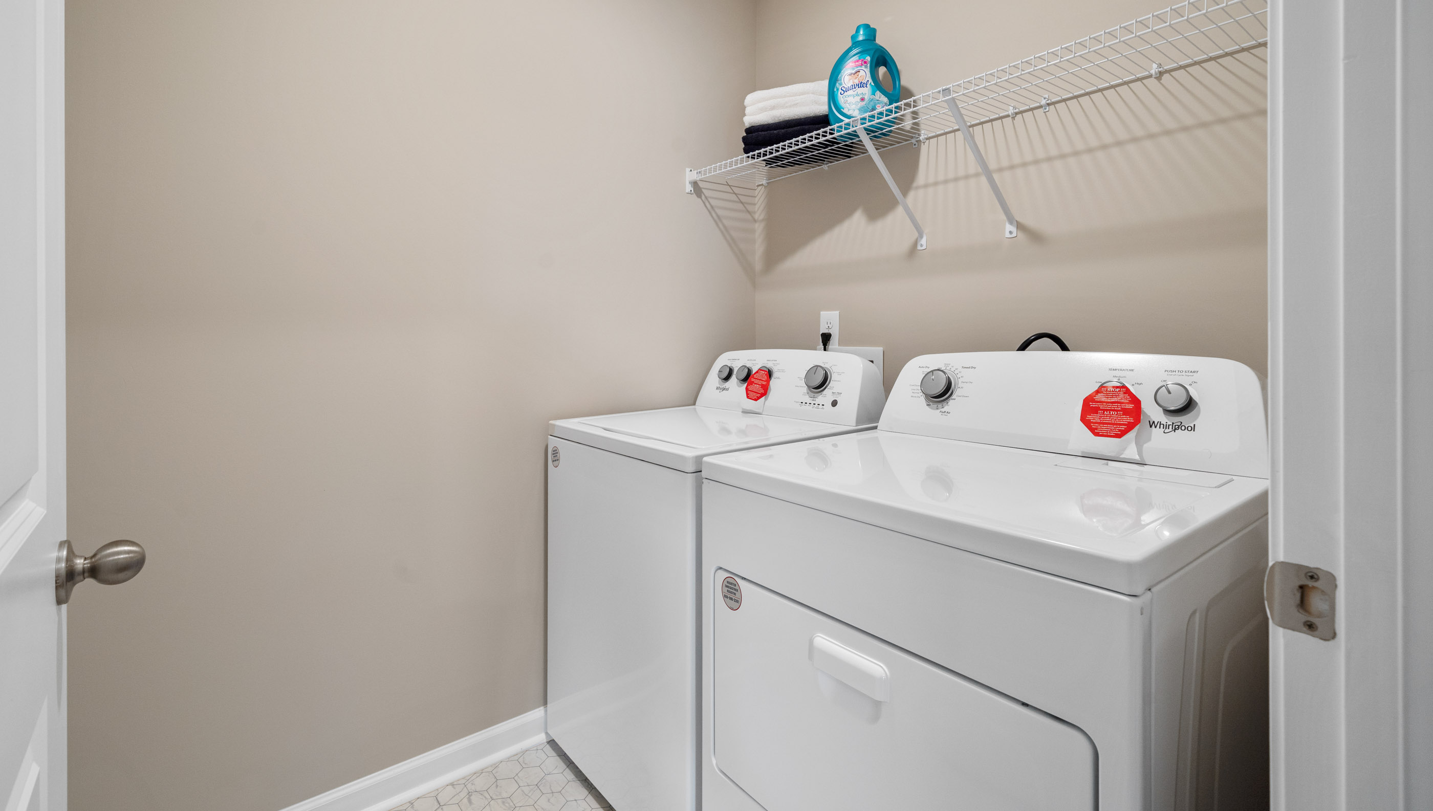 Laundry room with hanging storgae racks.