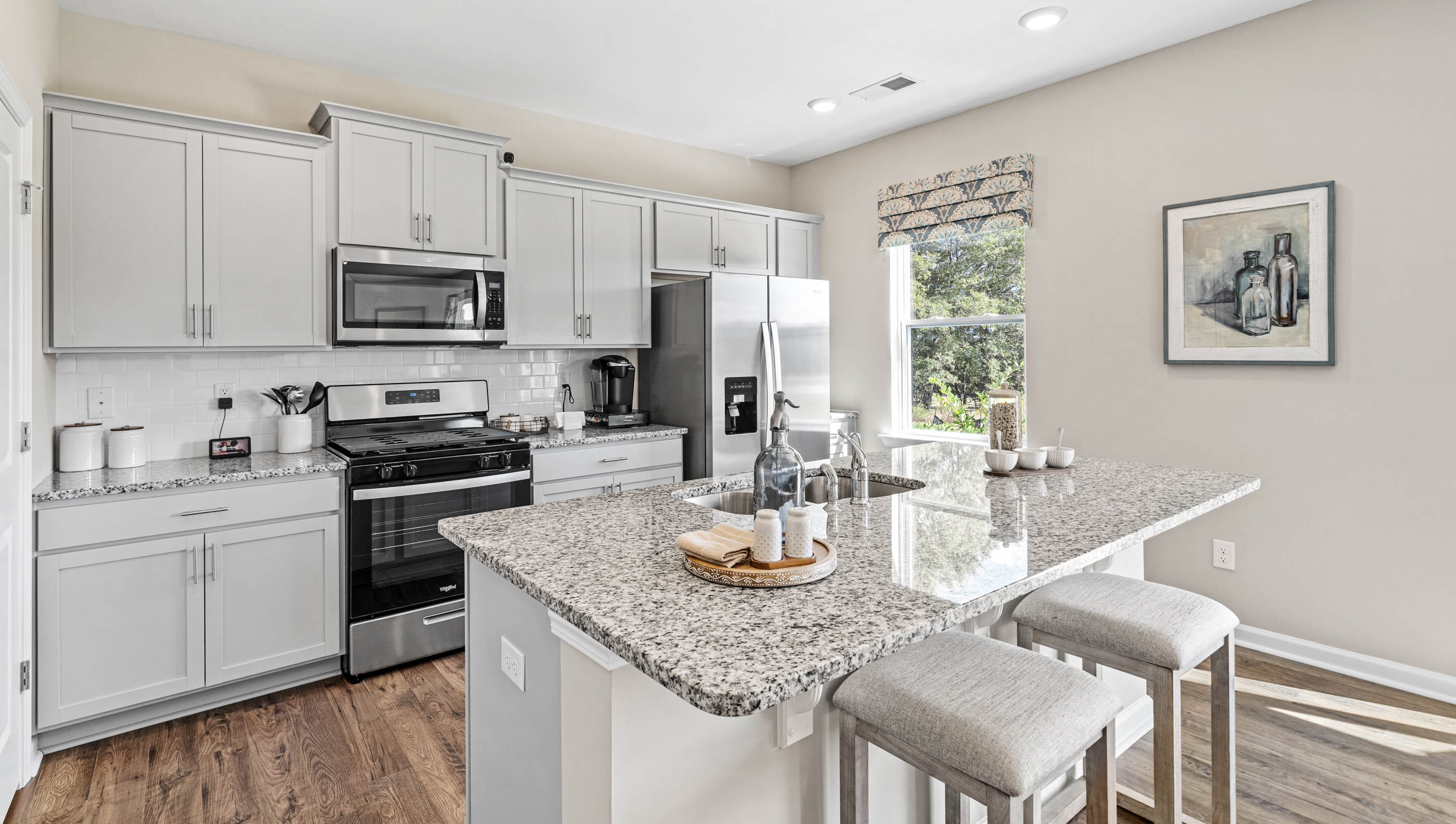 Kitchen and island with granite counter tops.