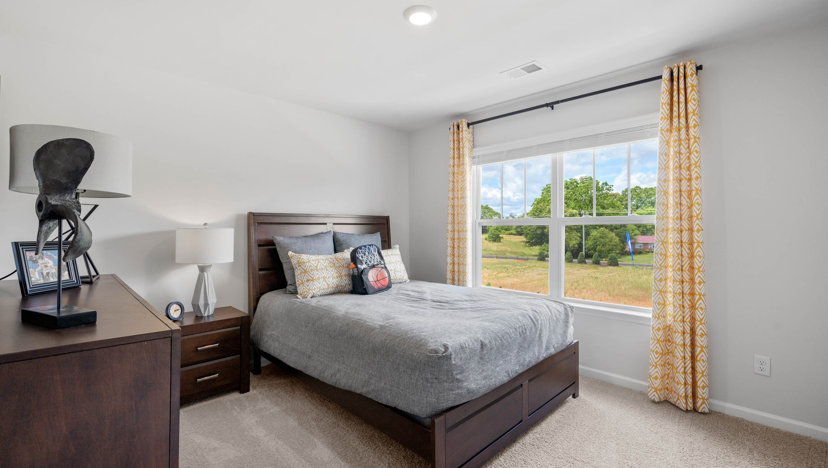 Bedroom with carpet and window.