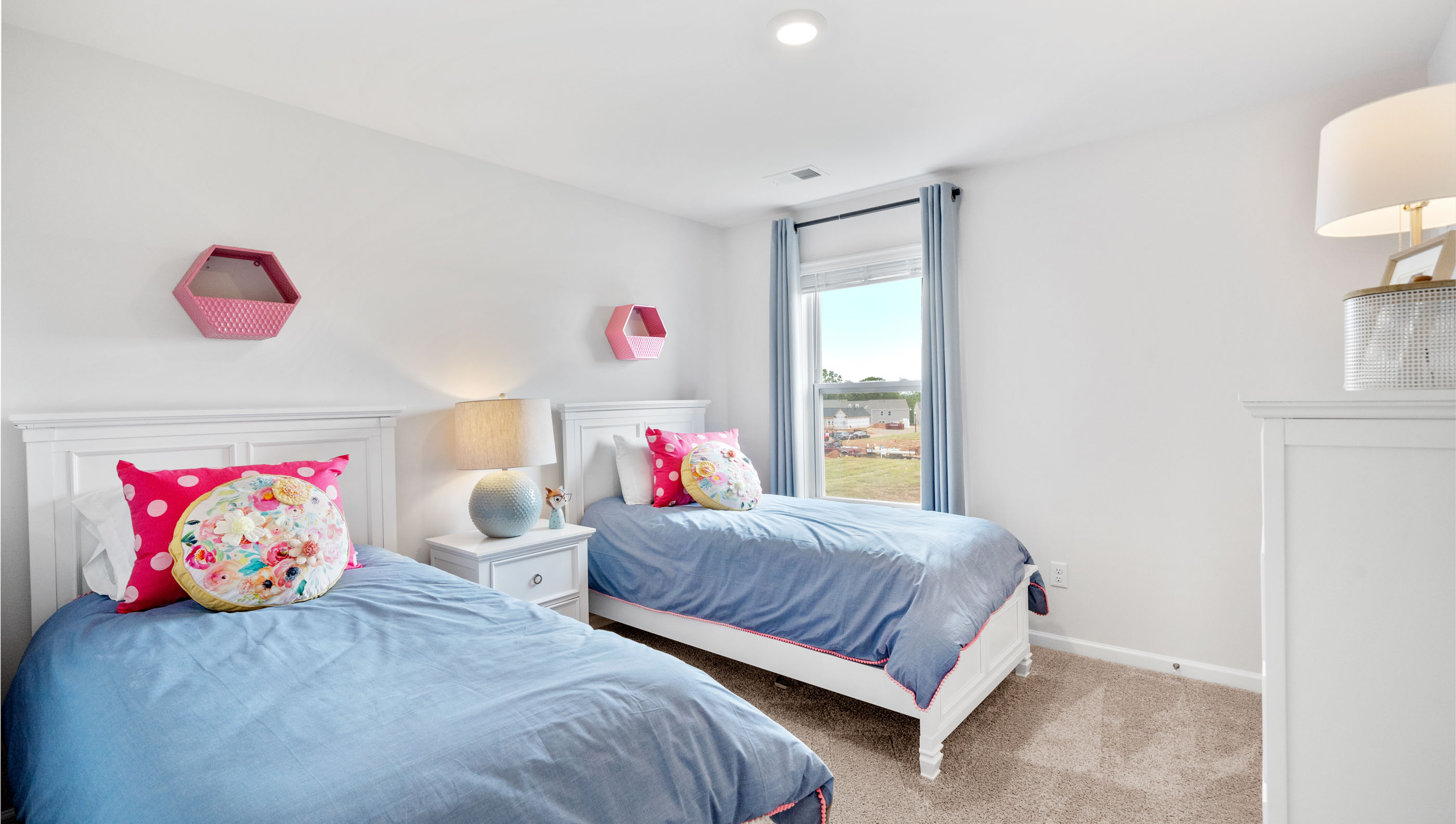 Bedroom with carpet and window.