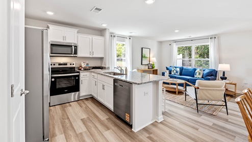 Kitchen with half island with granite counter tops.
