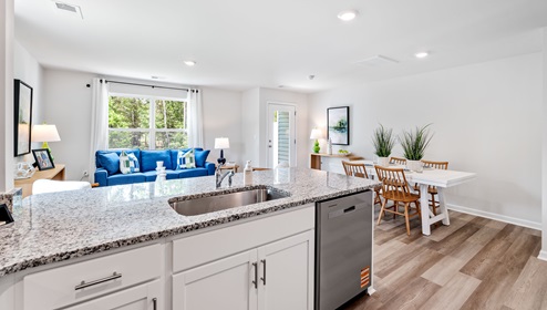 Kitchen with half island with granite counter tops.