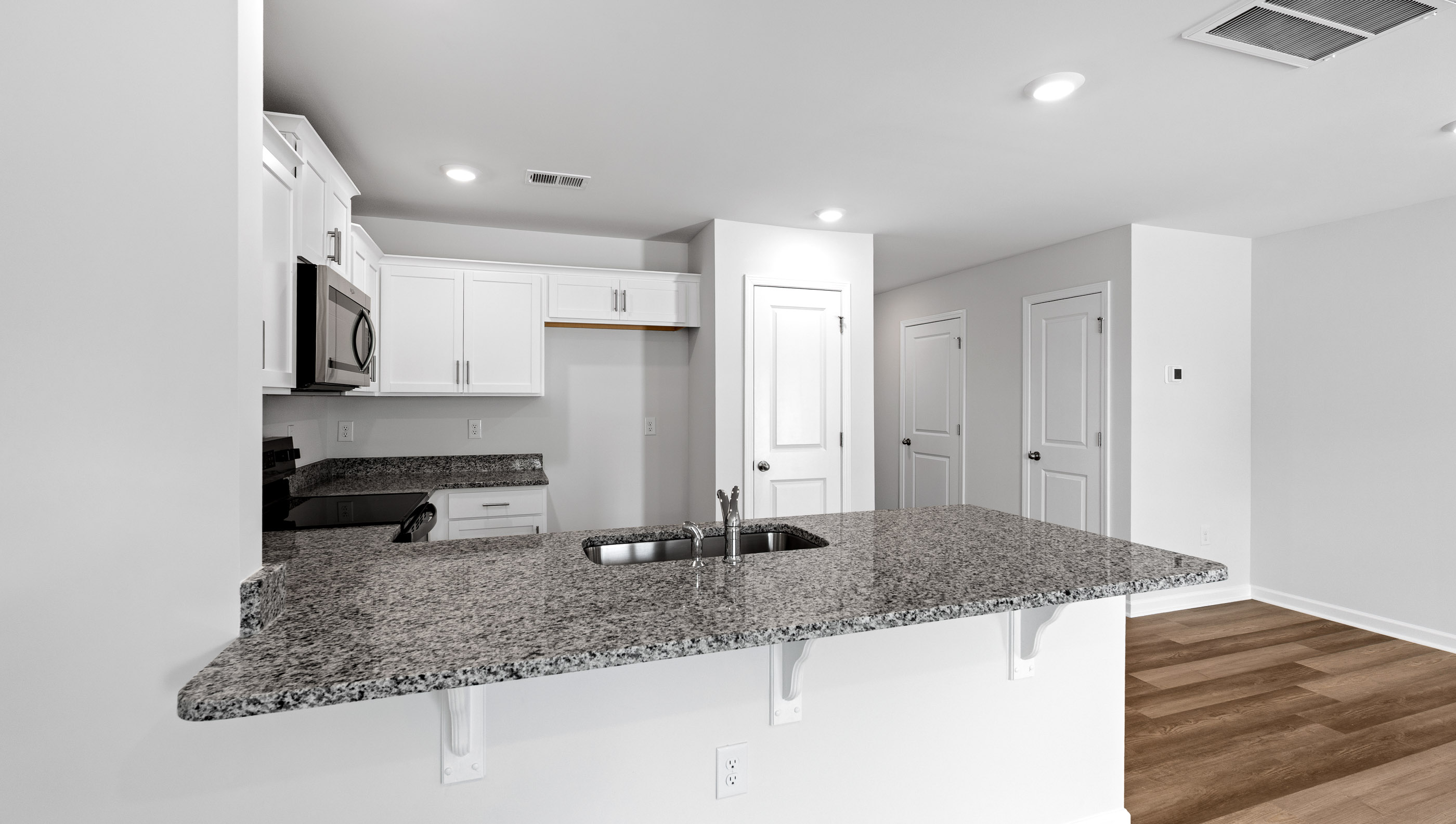 Kitchen has granite countertops.
