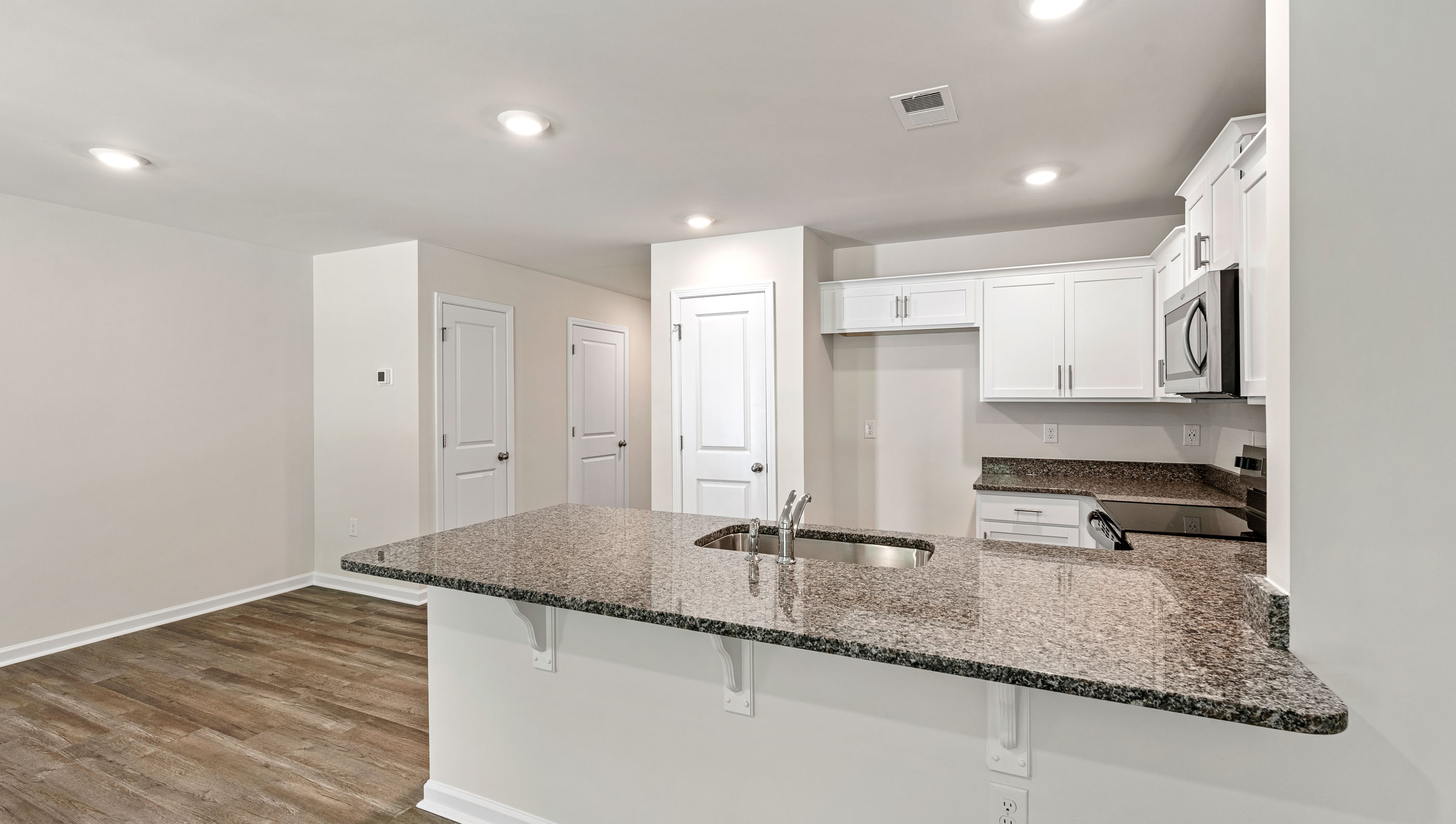Kitchen has granite countertops.