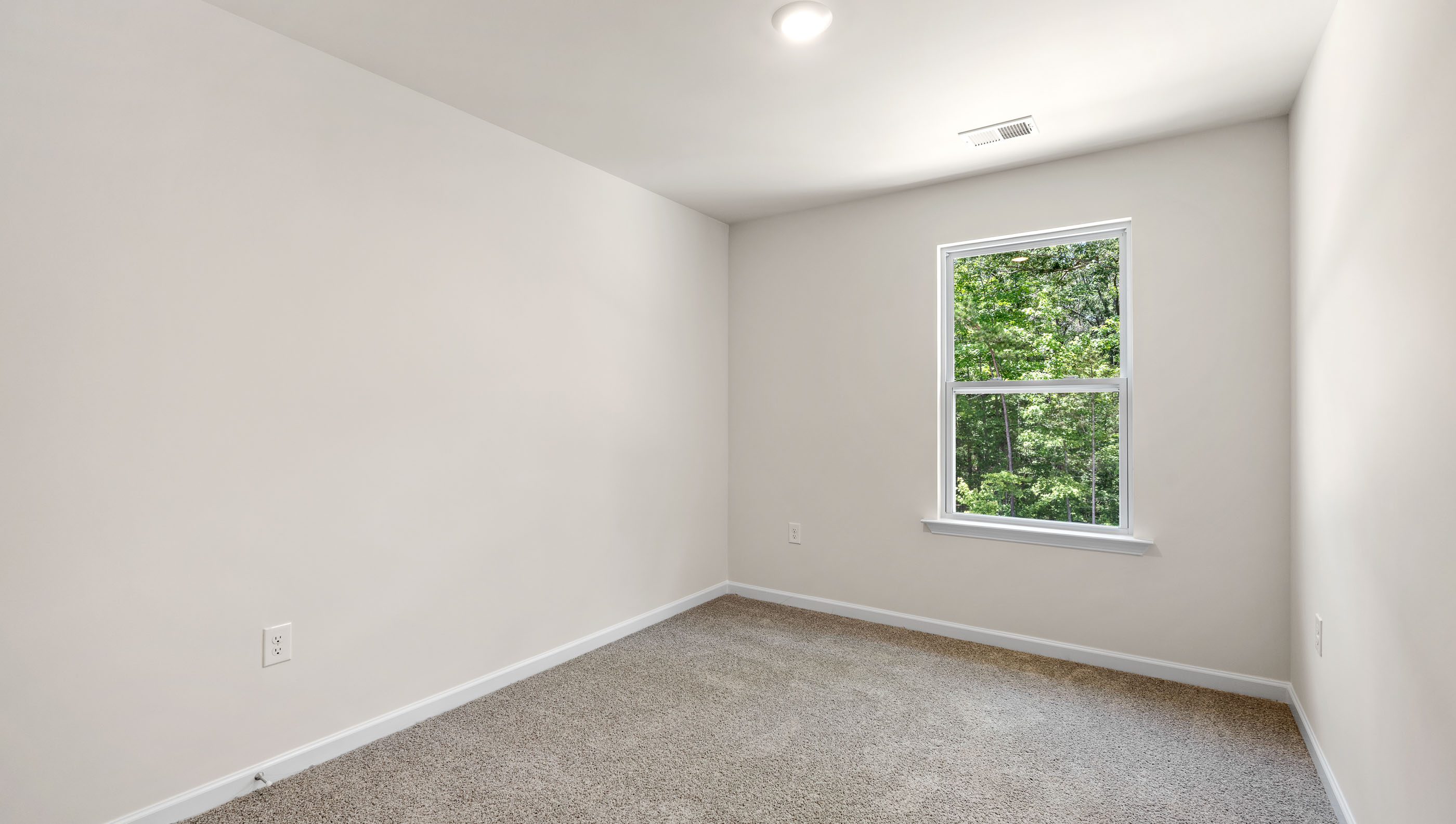 Bedroom with window and carpet.
