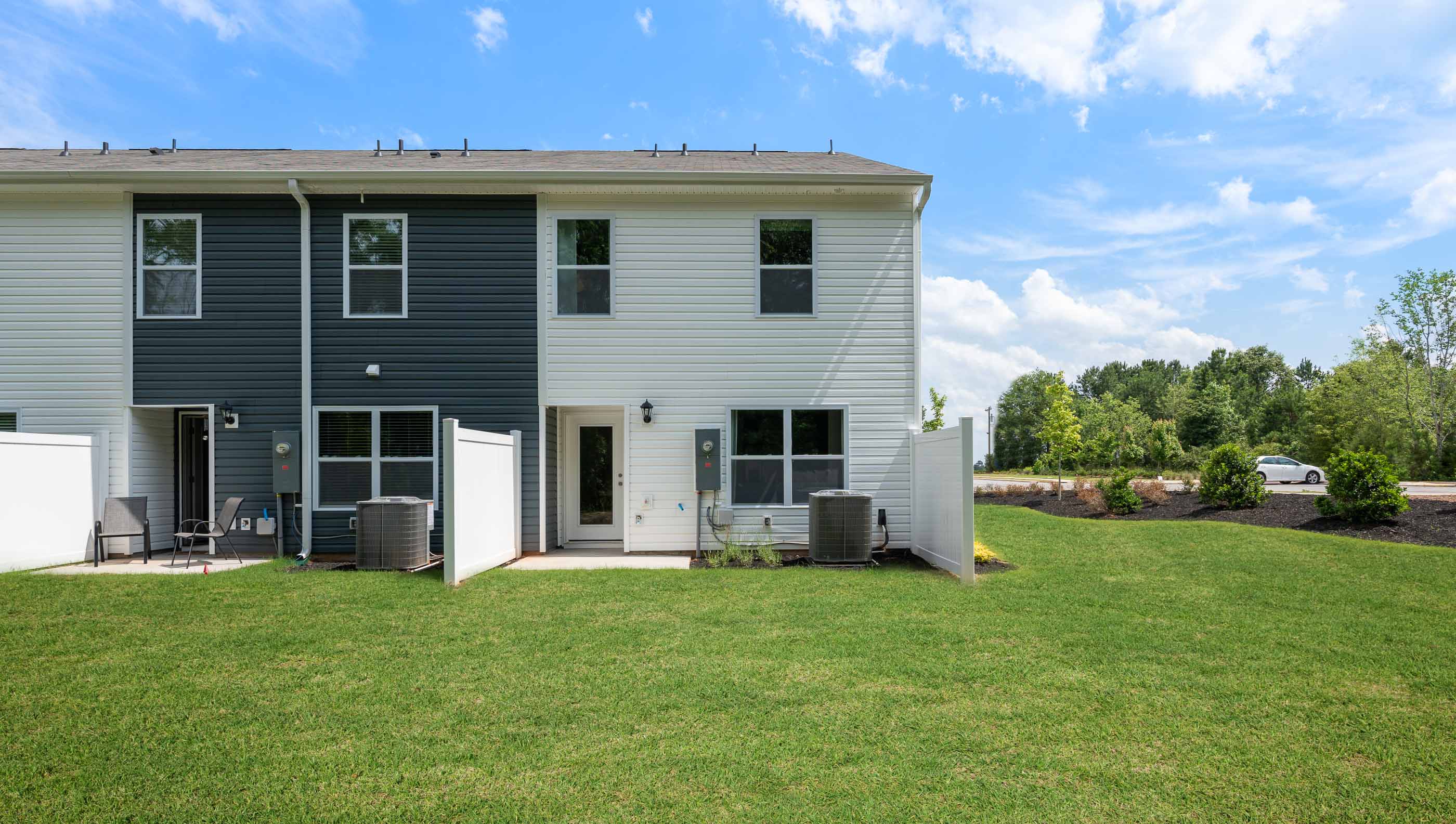 Back exterior with patio and large backyard.