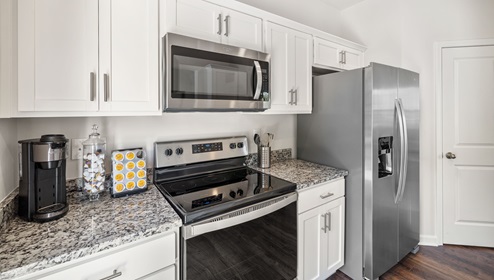Kitchen with granite counter tops and stainless steel appliances.