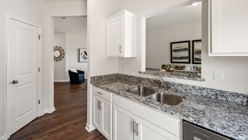 Kitchen with granite counter tops and stainless steel appliances.