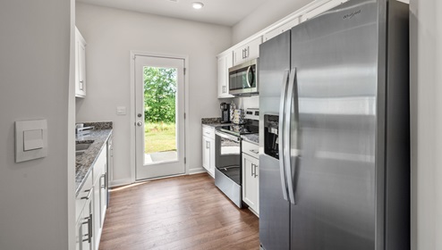 Kitchen with granite counter tops and stainless steel appliances.