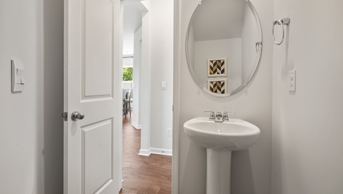 Half bathroom with mirror.