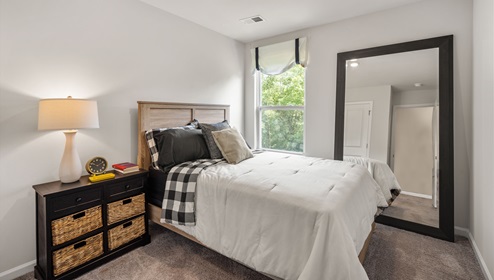 Bedroom with carpet and window.