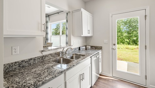 Kitchen with granite counter tops and stainless steel appliances.