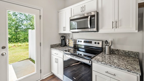 Kitchen with granite counter tops and stainless steel appliances.
