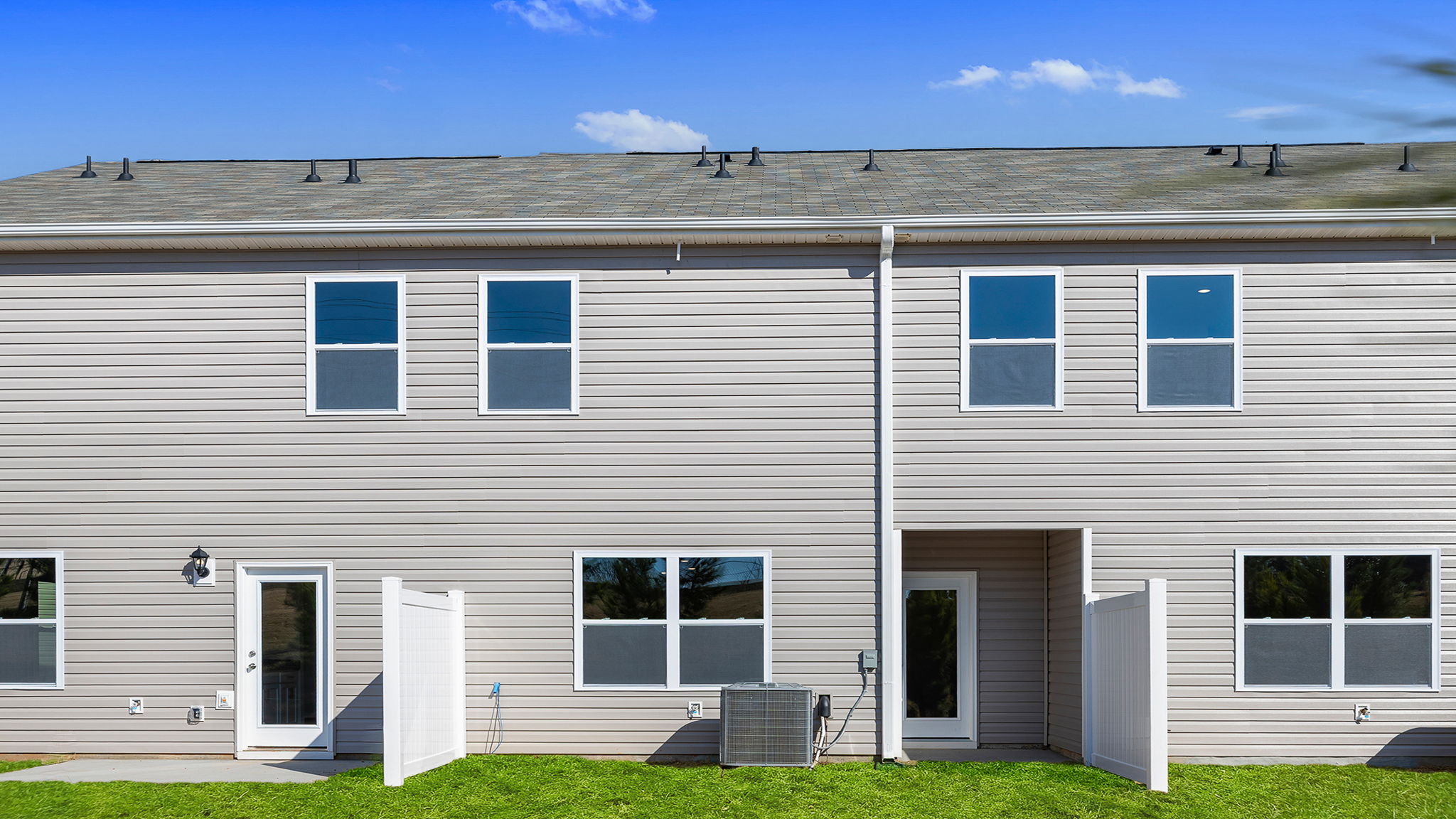 Back exterior view of home and patio.