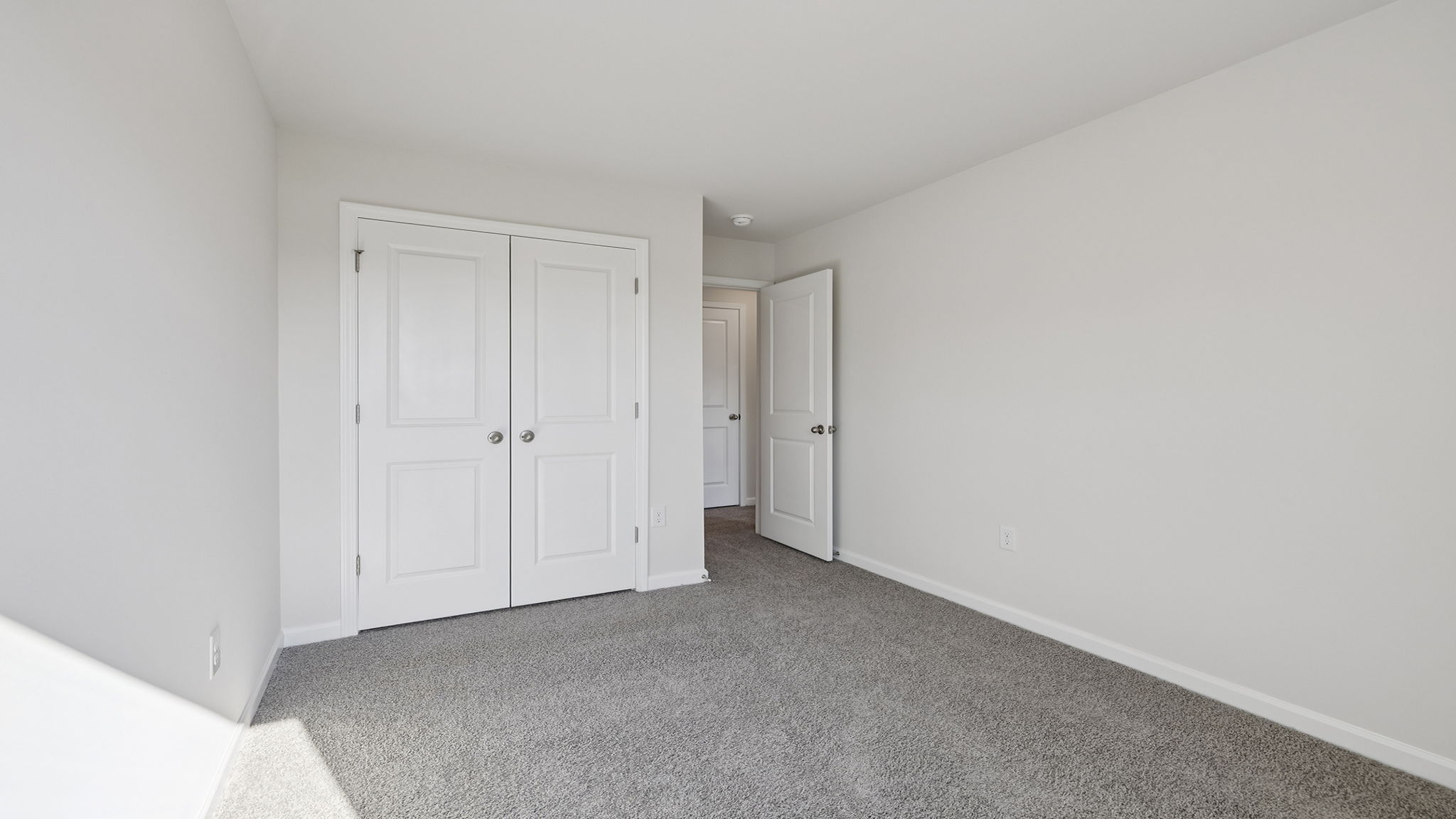 Bedroom with window and carpet.