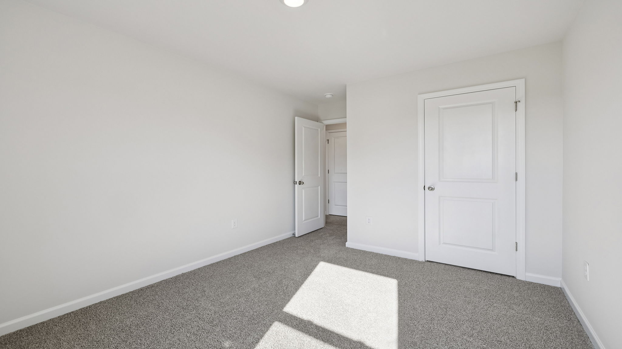 Bedroom with window and carpet.